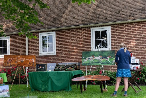Displays of paintings showing hounds or foxes.